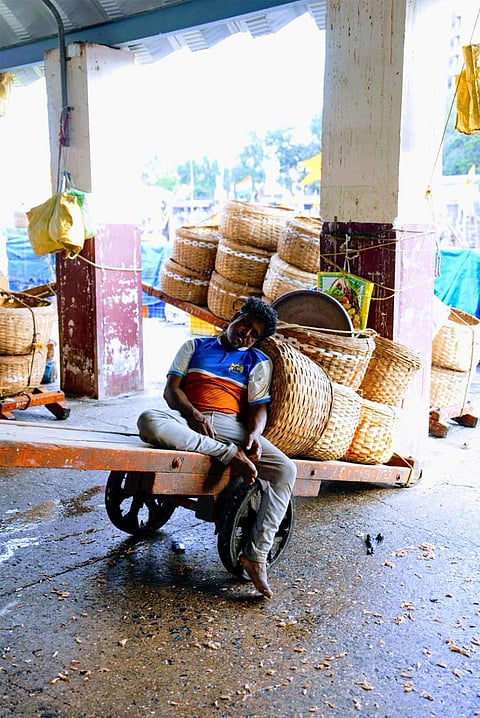 Boats rest and workers pause as daily life at Sassoon Dock faces a slowdown.
