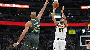 AP Photo : Denver Nuggets guard Jamal Murray, right, shoots over Minnesota Timberwolves center Rudy Gobert in the first half in Game 1 of a first-round NBA playoffs basketball series.