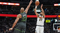 AP Photo : Denver Nuggets guard Jamal Murray, right, shoots over Minnesota Timberwolves center Rudy Gobert in the first half in Game 1 of a first-round NBA playoffs basketball series.