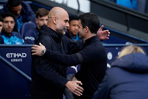 Manchester City's head coach Pep Guardiola hugs with Arsenal's manager Mikel Arteta during the English Premier League soccer match between Manchester City and and Arsenal, in Manchester, England.
