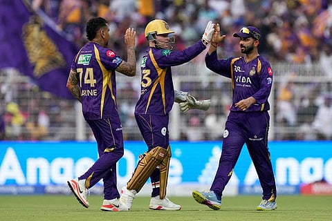 Kolkata Knight Riders' Sunil Narine, celebrates with teammate Tim Seifert and captain Ajinkya Rahane the wicket of Rajasthan Royals' Yashasvi Jaiswal during the Indian Premier League cricket match between Kolkata Knight Riders and Rajasthan Royals in Kolkata, India.