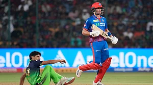 AP Photo : Delhi Capitals' Tristan Stubbs in action as Royal Challengers Bengaluru's Rasikh Salam watches during the IPL 2026 cricket match between Royal Challengers Bengaluru and Delhi Capitals in Bengaluru.