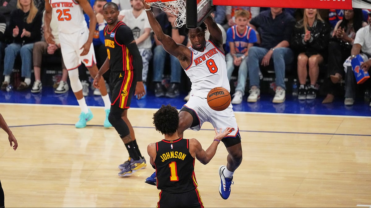 New York Knicks' Og Anunoby (8) dunks the ball in front of Atlanta Hawks' Jalen Johnson (1) during the first half in Game 1 of a first-round NBA playoffs basketball series. - AP Photo