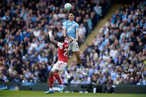 Manchester City's Nico O'Reilly heads the ball during the English Premier League soccer match between Manchester City and and Arsenal, in Manchester, England.