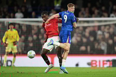 Chelsea's Liam Delap, right, and Manchester United's Ayden Heaven challenge for the ball during the English Premier League soccer match between Chelsea and Manchester United in London.