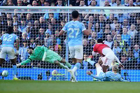 Manchester City's Erling Haaland scores his side's second goal during the English Premier League soccer match between Manchester City and and Arsenal, in Manchester, England.