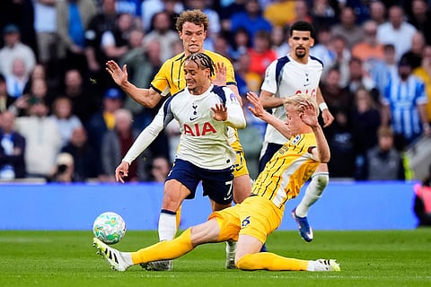 Tottenham Hotspur's Xavi Simons, left, and Brighton and Hove Albion's Jan Paul van Hecke battle for the ball during their English Premier League soccer match in London.