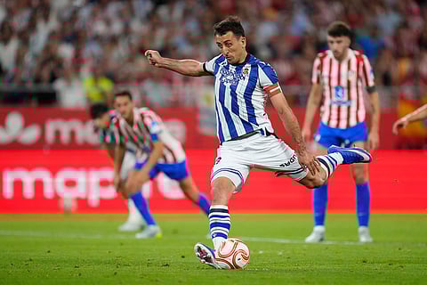Real Sociedad's Mikel Oyarzabal scores his side's second goal by a penalty during the Copa del Rey final soccer match between Atletico Madrid and Real Sociedad in Seville, Spain.