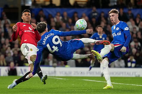 Manchester United's Casemiro, left, challenges for the ball with Chelsea's Alejandro Garnacho, center, and Chelsea's Cole Palmer during the English Premier League soccer match between Chelsea and Manchester United in London.