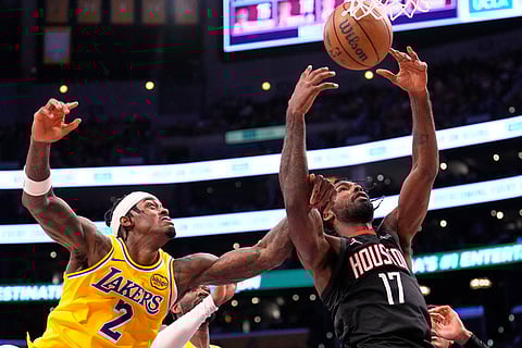 Los Angeles Lakers forward Jarred Vanderbilt, left, and Houston Rockets forward Tari Eason go after a rebound during the second half in Game 1 of a first-round NBA playoffs basketball series in Los Angeles.