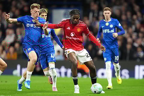 Manchester United's Ayden Heaven, center right, and Chelsea's Liam Delap challenge for the ball during the English Premier League soccer match between Chelsea and Manchester United in London.