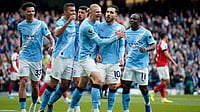 | Photo: AP/Dave Thompson : Manchester City's Rayan Cherki celebrates with his teammates after scoring his side's first goal during the English Premier League soccer match between Manchester City and and Arsenal, in Manchester, England, Sunday, April 19, 2026. 