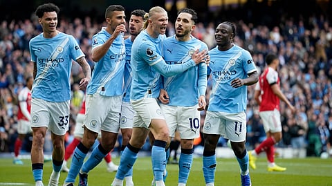 Manchester City's Rayan Cherki celebrates with his teammates after scoring his side's first goal during the English Premier League soccer match between Manchester City and and Arsenal, in Manchester, England, Sunday, April 19, 2026. 