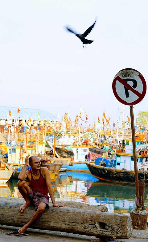At Sassoon Dock, stillness replaces the usual rush—boats anchored, nets folded, and fishermen waiting for better days.
