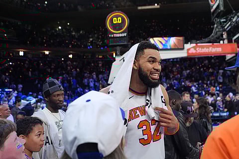 New York Knicks' Karl-Anthony Towns (32) smiles after talking to loved ones after Game 1 of a first-round NBA playoffs basketball series against the Atlanta Hawks in New York.