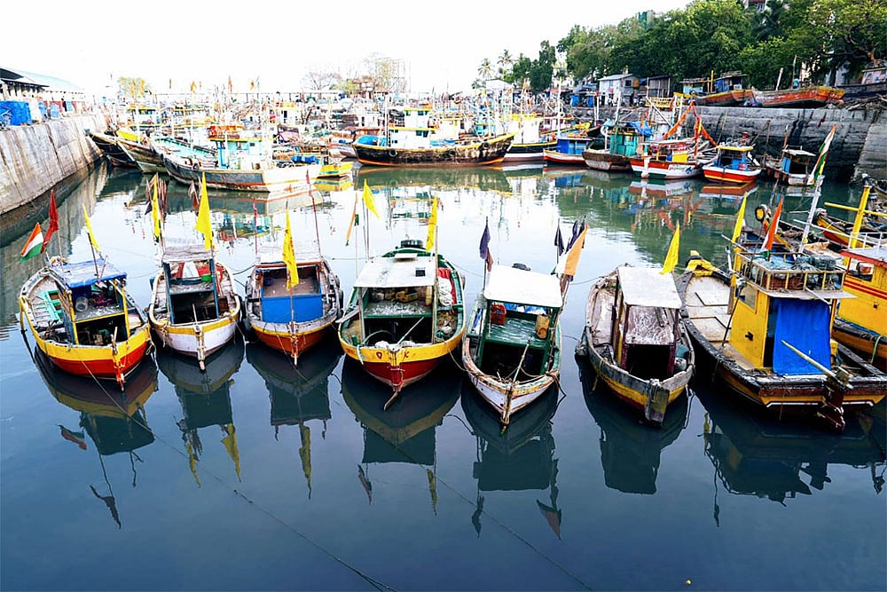 Boats rest, and workers pause as daily life at Sassoon Dock faces a slowdown. - | Photo: Dinesh Parab