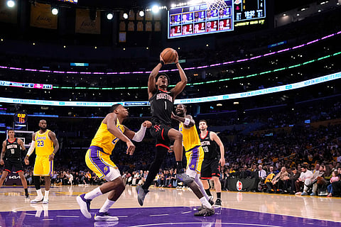 Houston Rockets guard Amen Thompson, center, shoots as Los Angeles Lakers forward Rui Hachimura, third from left, and center Deandre Ayton defend during the first half in Game 1 of a first-round NBA playoffs basketball series in Los Angeles.