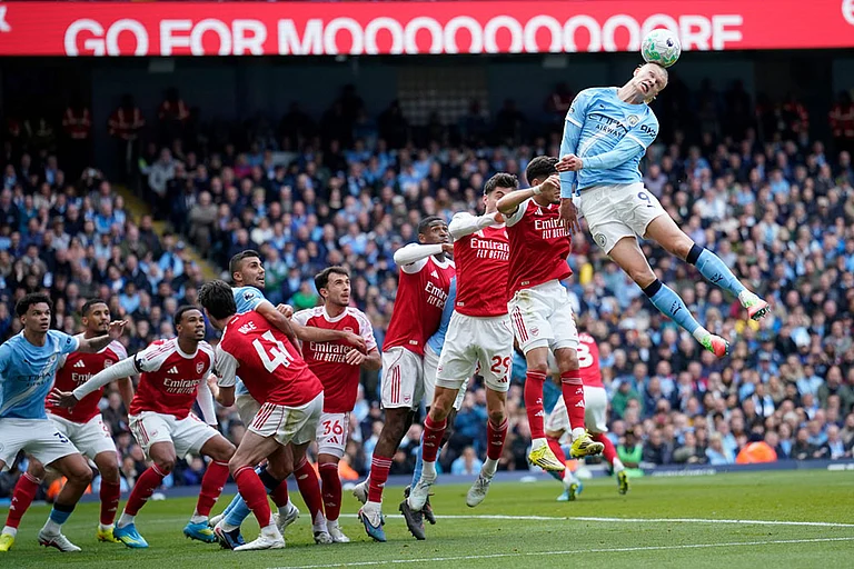 Manchester City's Erling Haaland heads the ball during the English Premier League soccer match between Manchester City and and Arsenal, in Manchester, England. - | Photo: AP/Dave Thompson
