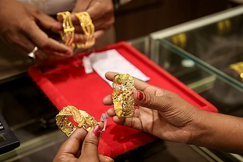 A person buys gold jewellery on the occasion of 'Akshaya Tritiya', an annual Jain and Hindu spring festival, in Agartala, Tripura.