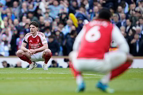 Arsenal's Declan Rice reacts at the end of the English Premier League soccer match between Manchester City and and Arsenal, in Manchester, England.