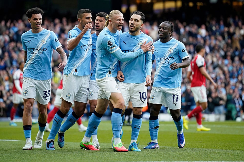 Manchester City's Rayan Cherki celebrates with his teammates after scoring his side's first goal during the English Premier League soccer match between Manchester City and and Arsenal, in Manchester, England. - | Photo: AP/Dave Thompson
