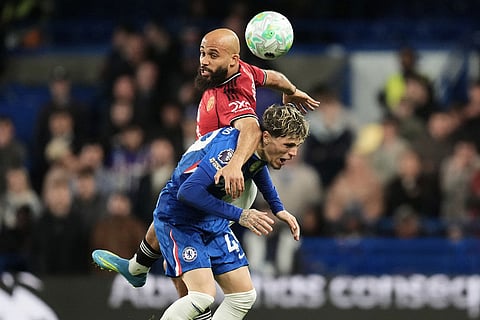Manchester United's Bryan Mbeumo, top, and Chelsea's Alejandro Garnacho challenge for the ball during the English Premier League soccer match between Chelsea and Manchester United in London.