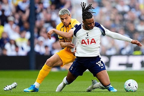 Brighton and Hove Albion's Diego Gomez, left, and Tottenham Hotspur's Destiny Udogie battle for the ball during their English Premier League soccer match in London.