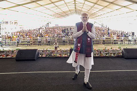 In this image released on April 19, 2026, Prime Minister Narendra Modi greets during a 'Vijay Sankalp rally' ahead of West Bengal Assembly elections, in Purulia.