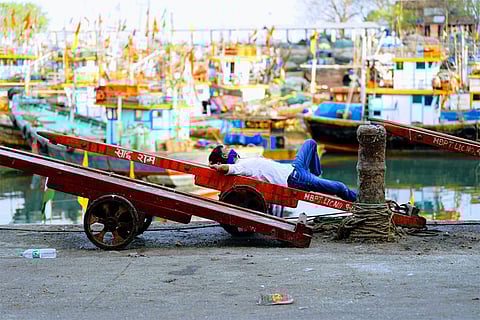 At Sassoon Dock, stillness replaces the usual rush—boats anchored, nets folded, and fishermen waiting for better days.