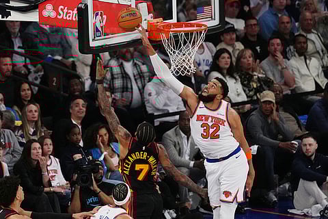 New York Knicks' Karl-Anthony Towns (32) blocks a shot by Atlanta Hawks' Nickeil Alexander-Walker (7) during the first half in Game 1 of a first-round NBA playoffs basketball series in New York.