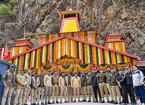 Police officials pose for a group picture after the doors of the Yamunotri shrine were opened for the annual Char Dham Yatra, in Uttarkashi.