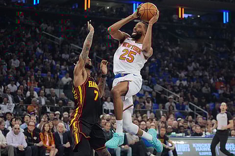 New York Knicks' Mikal Bridges (25) shoots over Atlanta Hawks' Nickeil Alexander-Walker (7) during the first half in Game 1 of a first-round NBA playoffs basketball series in New York.