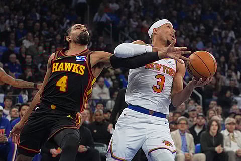 Atlanta Hawks' Gabe Vincent (4) knocks the ball away from New York Knicks' Josh Hart (3) during the first half in Game 1 of a first-round NBA playoffs basketball series in New York.