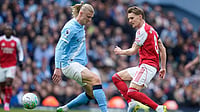 Premier League 2025-26: Haaland Makes Difference As Man City Beat Arsenal To Take Control Of Title Race Photo: AP/Dave Thompson : Manchester City's Erling Haaland challenges for the ball with Arsenal's Martin Odegaard during the English Premier League soccer match between Manchester City and and Arsenal, in Manchester, England.
