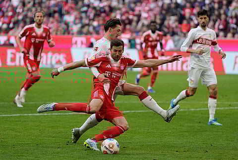 Stuttgart's Angelo Stiller holds Bayern's Leon Goretzka during a Bundesliga soccer match between Bayern and Stuttgart in Munich, Germany.