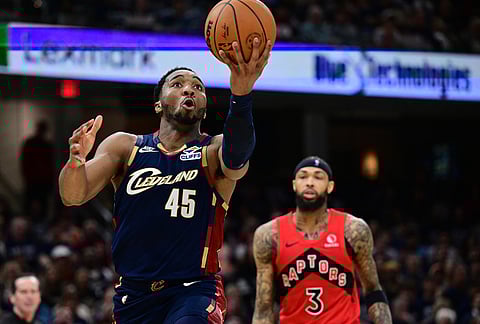 Cleveland Cavaliers guard Donovan Mitchell goes to the basket against the Toronto Raptors during the second half in Game 1 of a first-round NBA playoffs basketball series, in Cleveland.