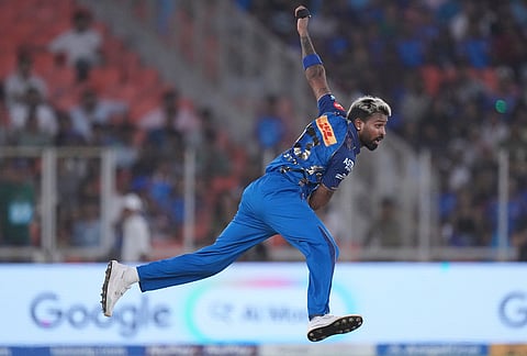 Mumbai Indians' captain Hardik Pandya bowls a delivery during the Indian Premier League cricket match between Gujarat Titans and Mumbai Indians in Ahmedabad.