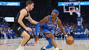 | Photo: AP/Nate Billings : Oklahoma City Thunder guard Shai Gilgeous-Alexander, right, handles the ball against Phoenix Suns guard Collin Gillespie, left, during the second half in Game 1 of a first-round NBA playoffs basketball series Sunday, April 19, 2026, in Oklahoma City.