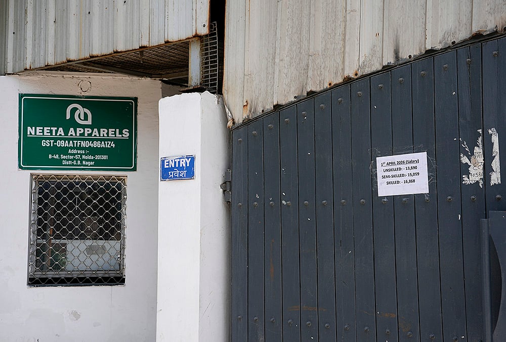 noida workers protest Signs announcing revised wages