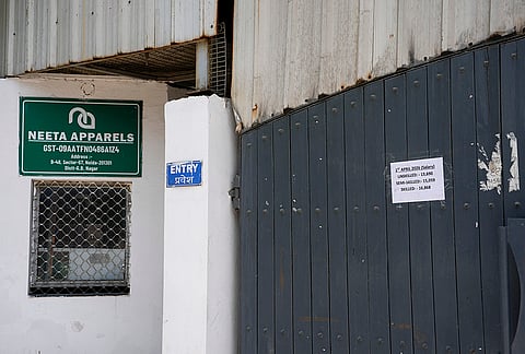 Signs announcing revised wages on closed gates of factories in Sec 57 Industrial Area, Noida.