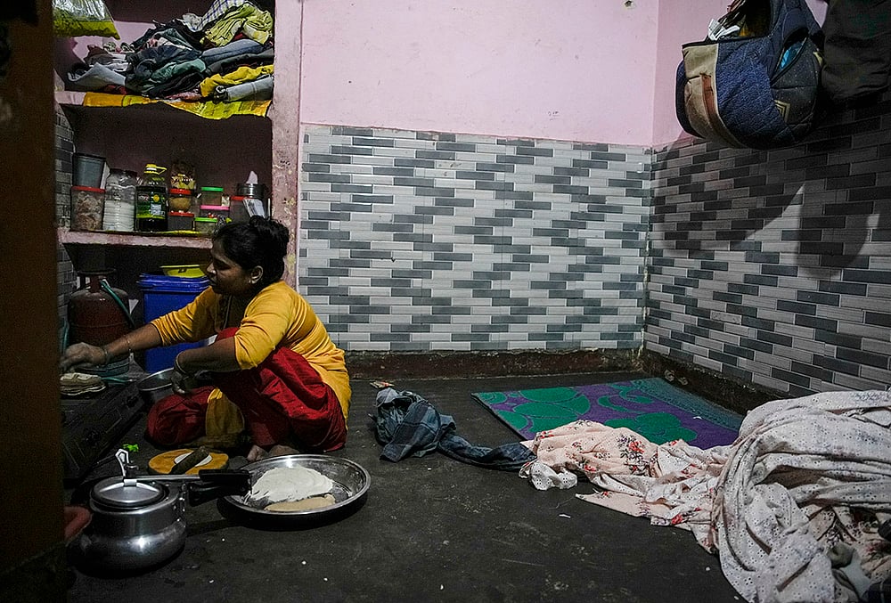 factory workers single-room, A woman prepares a meal 