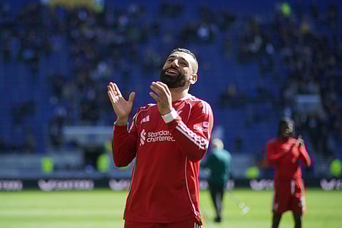 Liverpool's Mohamed Salah greets fans after the English Premier League soccer match between Everton and Liverpool in Liverpool, England.