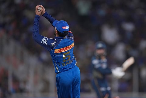 Mumbai Indians' Raj Angad Bawa takes the catch to dismiss Gujarat Titans' Rashid Khan during the Indian Premier League cricket match between Gujarat Titans and Mumbai Indians in Ahmedabad.