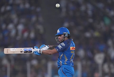 Mumbai Indians' Tilak Verma hits a six during the Indian Premier League cricket match between Gujarat Titans and Mumbai Indians in Ahmedabad.