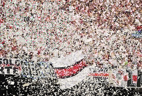 River Plate fans throw paper and confetti as their team enters the field for an Argentine league match against Boca Juniors in Buenos Aires, Argentina.