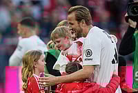 Bayern Munich Vs VFB Stuttgart, Bundesliga 2025-26: Bavarians Lift German Top-Flight Title With 4-2 Win | Photo: AP/Matthias Schrader : Bayern's Harry Kane hugs his kids after his team clinched the German league title after a Bundesliga soccer match between Bayern and Stuttgart in Munich, Germany.