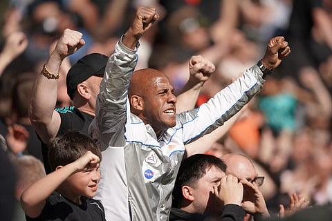 Liverpool's fans celebrate after the English Premier League soccer match between Everton and Liverpool in Liverpool, England.