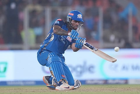 Mumbai Indians' Tilak Verma hits a six during the Indian Premier League cricket match between Gujarat Titans and Mumbai Indians in Ahmedabad.