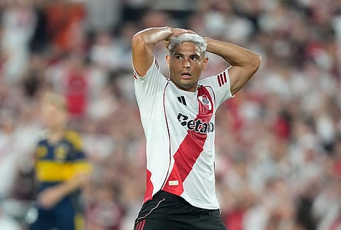 River Plate's Maximiliano Salas holds his head after missing a chance to score against Boca Juniors during an Argentine soccer league match in Buenos Aires, Argentina.