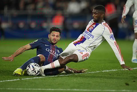 PSG's Goncalo Ramos, left, and Lyon's Clinton Mata challenge for the ball during the French League One soccer match between Paris Saint-Germain and Olympique Lyon in Paris, France.
